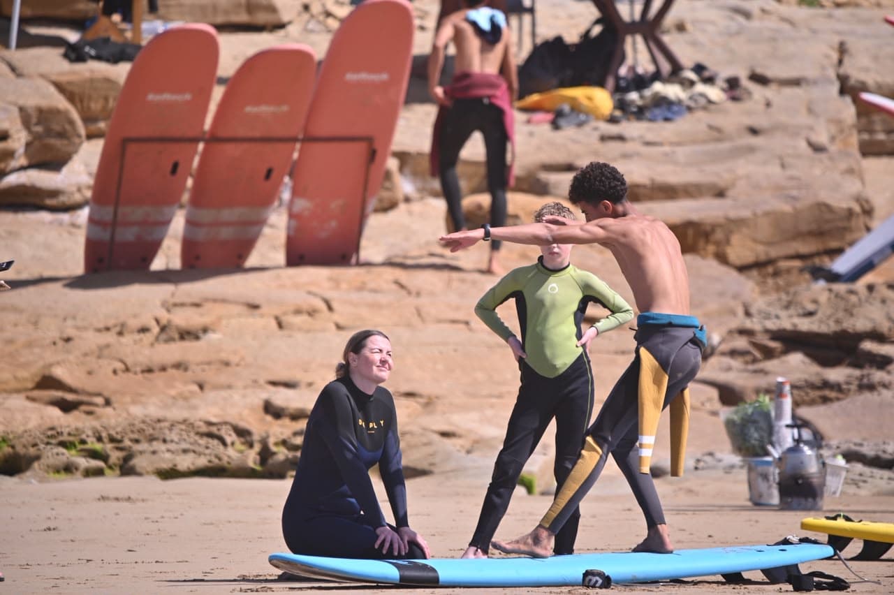 Soft boards lined up beside the rocks at the Taghazout meeting point
